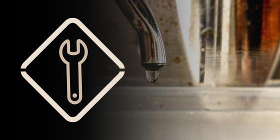 hand holding a steaming milk pitcher with a wrench icon representing tools and techniques for the art of coffee making and barista skills 8 methods 8 tools 8 techniques